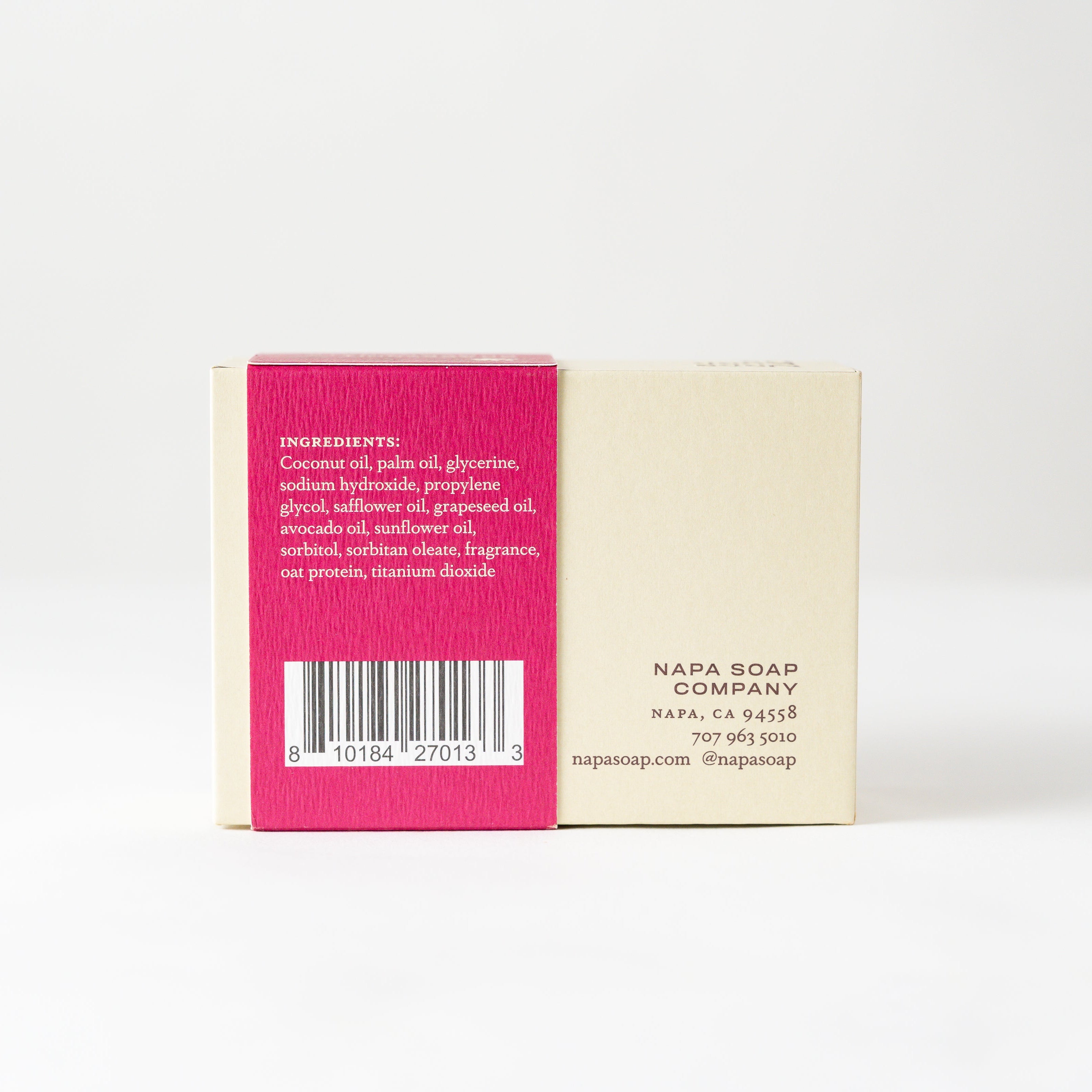 Bar of soap with pink and beige label on a white background