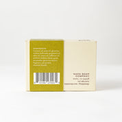 Back of a soap packaging box with text and a barcode on a white background