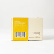 Bar of soap with a yellow and white label on a white background