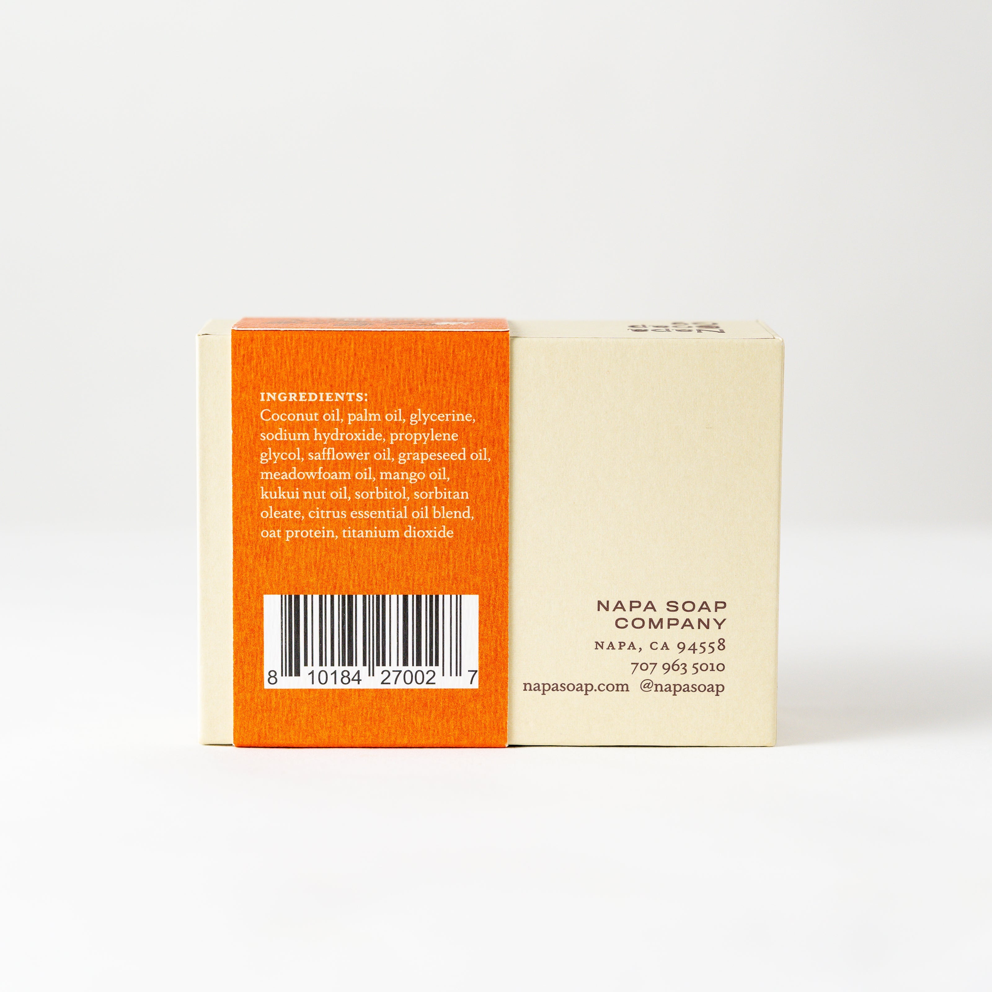 Back view of a soap bar with an orange label on a white background