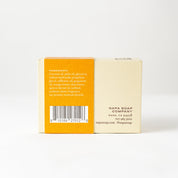 Bar of soap with an orange label on a white background