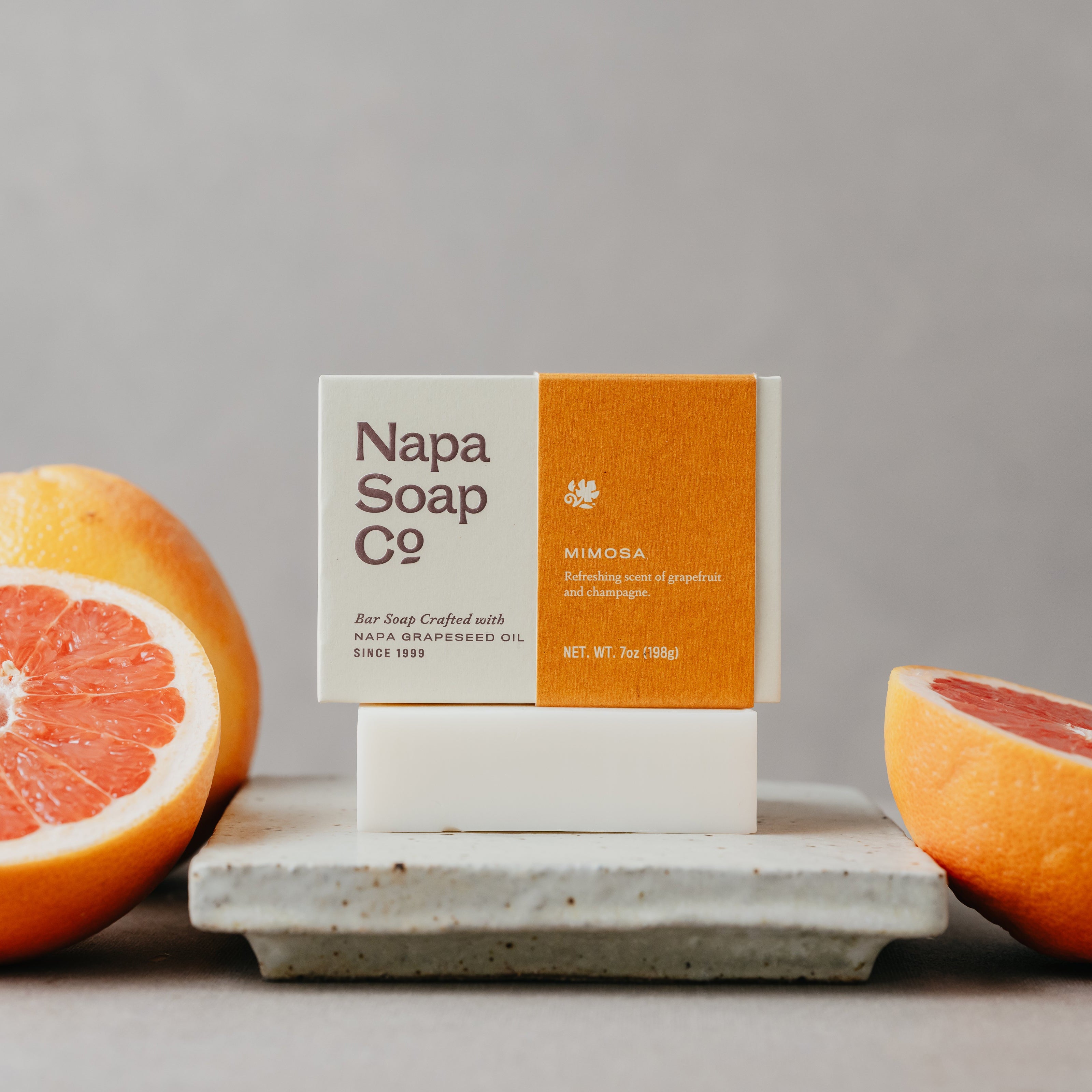Napa Soap Co bar of soap on a gray surface with grapefruits