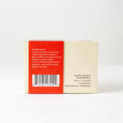 Back view of a soap packaging with red and beige sections on a white background