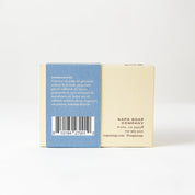 Bar of soap with a blue and white label on a white background