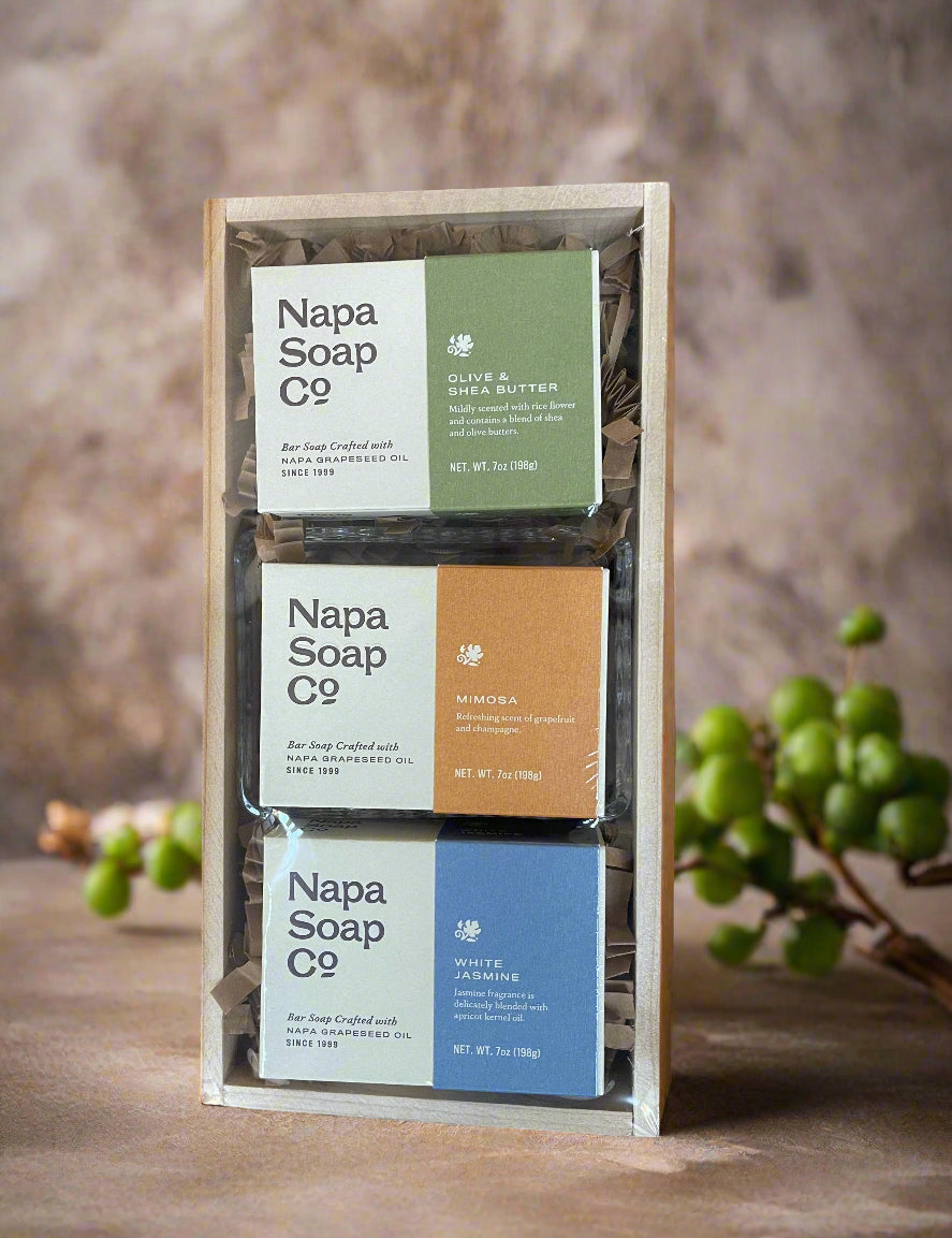 Three Napa Soap Co. soap bars in a wooden holder with a natural background.