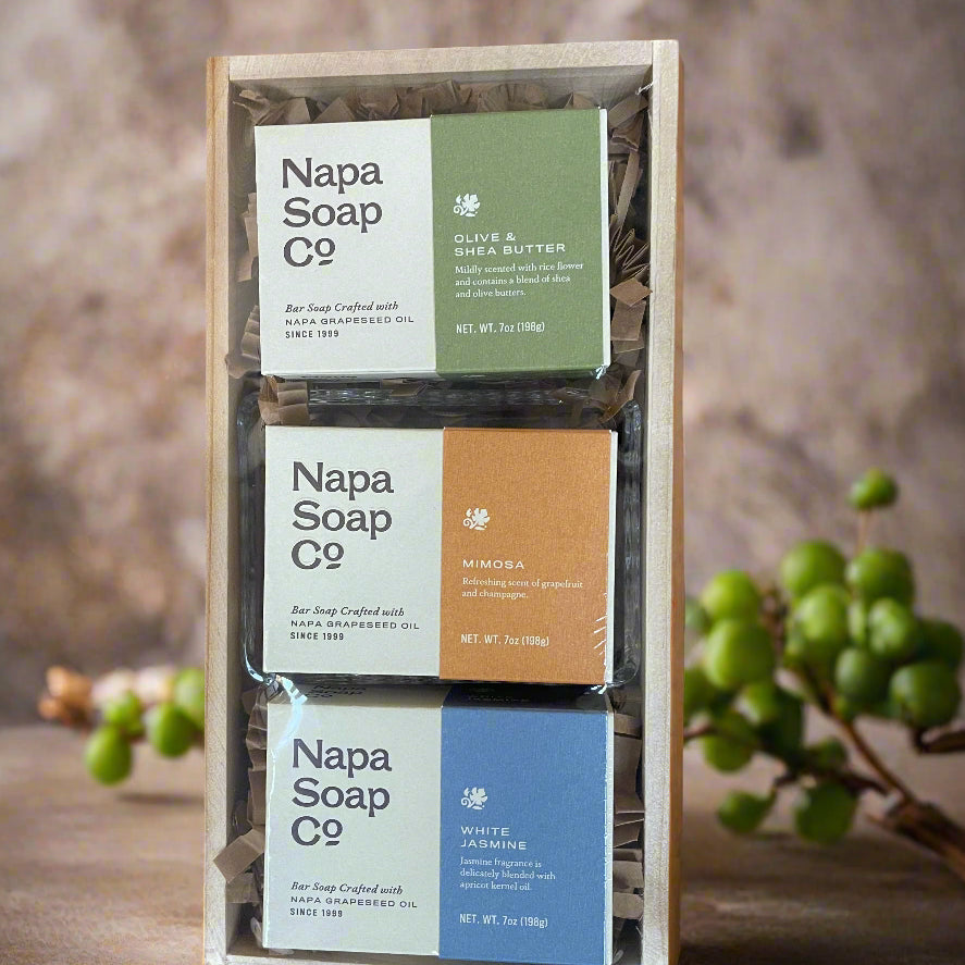 Three Napa Soap Co. soap bars in a wooden holder with a natural background.