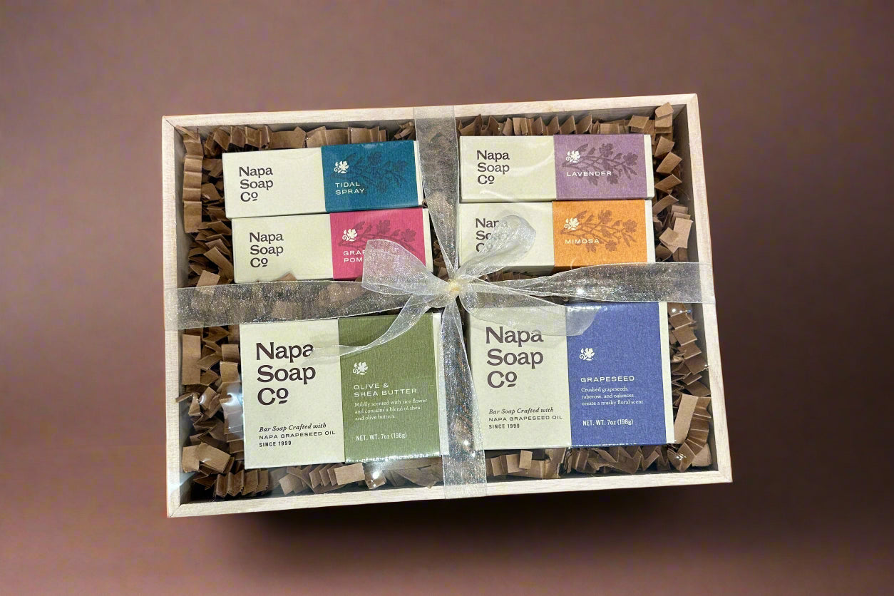 Set of Napa Soap Co. soaps in a wooden box on a brown background