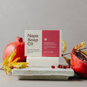 Napa Soap Co bar soap with pomegranate on a gray background