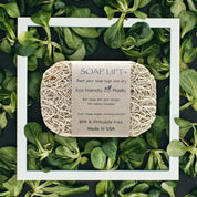Soap lift with eco-friendly label on a bed of green leaves